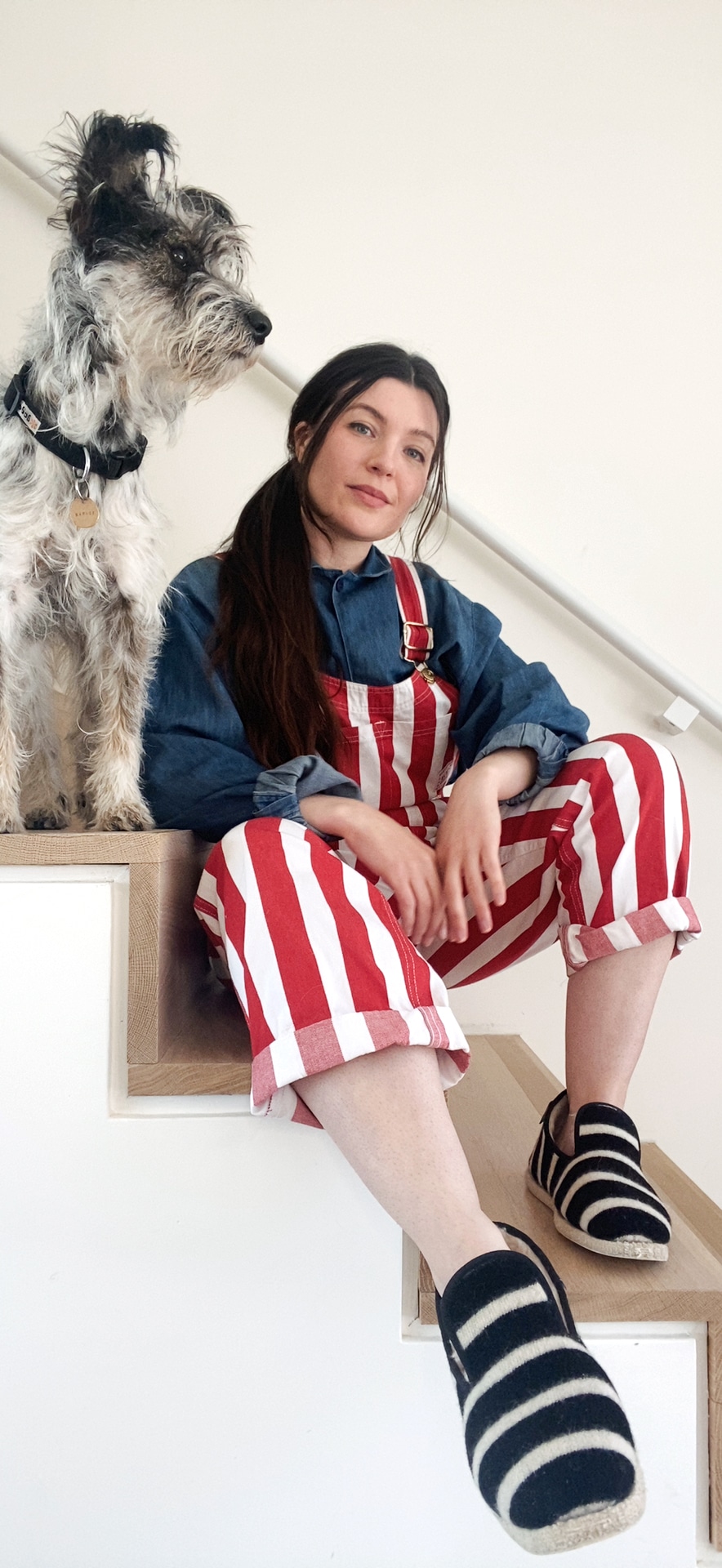 Claire Vogel and dog sitting on stairs