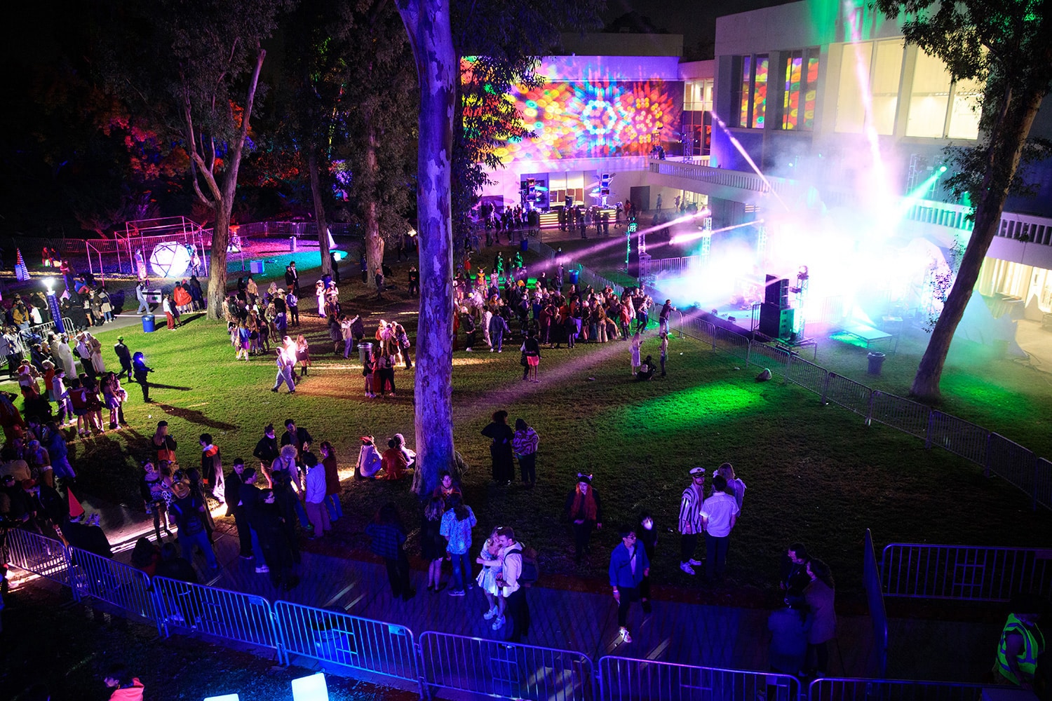 a nighttime shot of CalArts with lights and people milling about