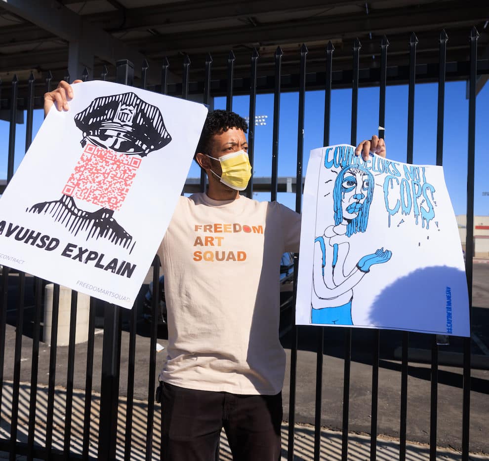 a man in mask carries two protest signs