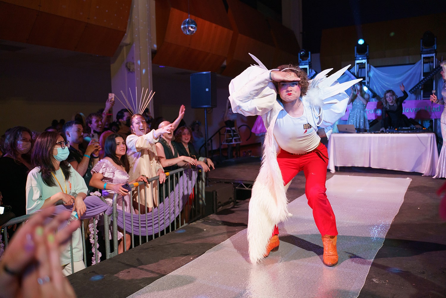 Person wearing wings poses on a runway in the Main Gallery.