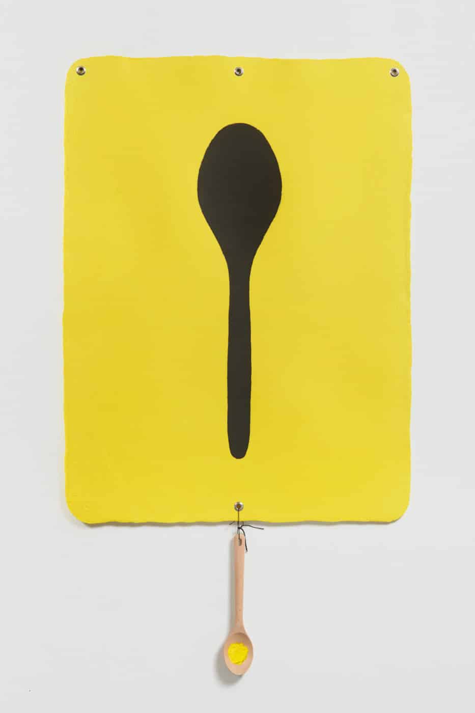 Artwork of a yellow painting with a silhouette of a spoon with a wooden spoon hanging from the painting by B. Wurtz (CalArts ’80)