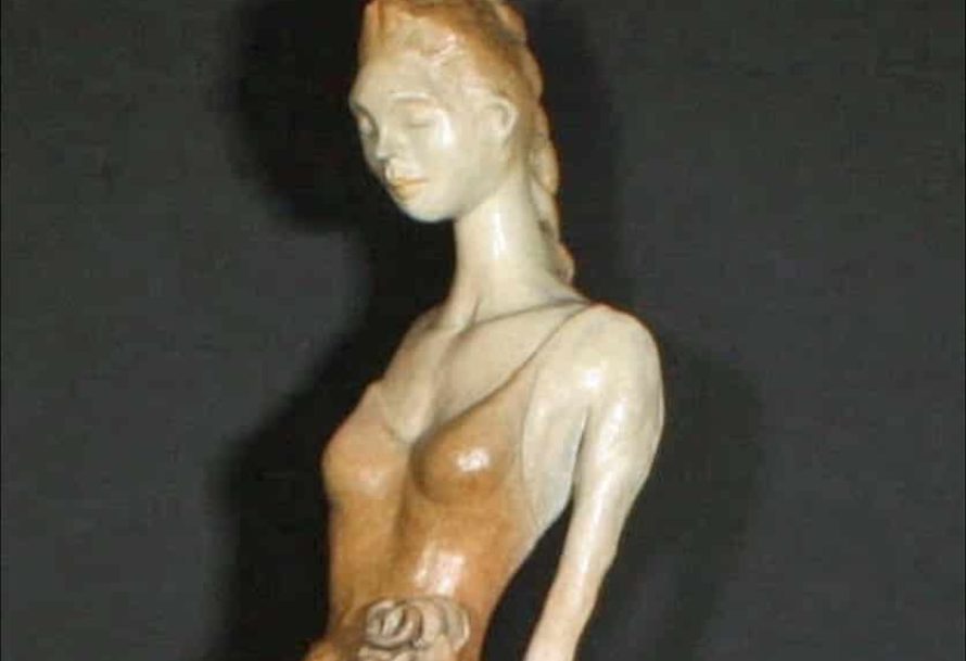 Bronze sculpture of ballerina in relaxed standing pose.