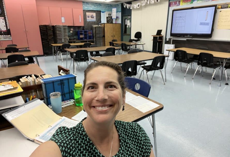 Jessica Diaz smiling in selfie taken in empty colorful classroom