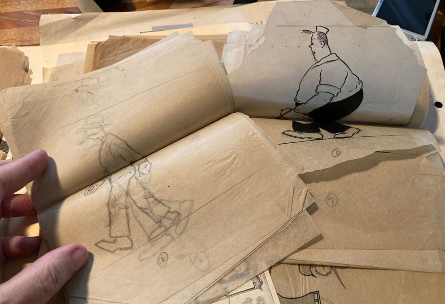 Stacks of papers featuring pencil-drawn walk cycles of two male characters