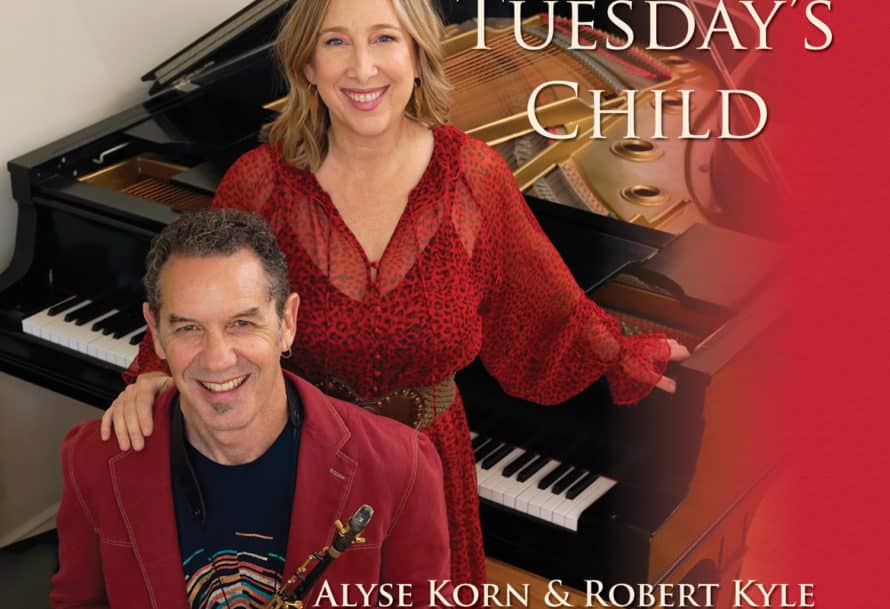 Alyse Korn and Robert Kyle's duo album cover for 'Tuesday's Child' featuring the artists smiling at a piano bench