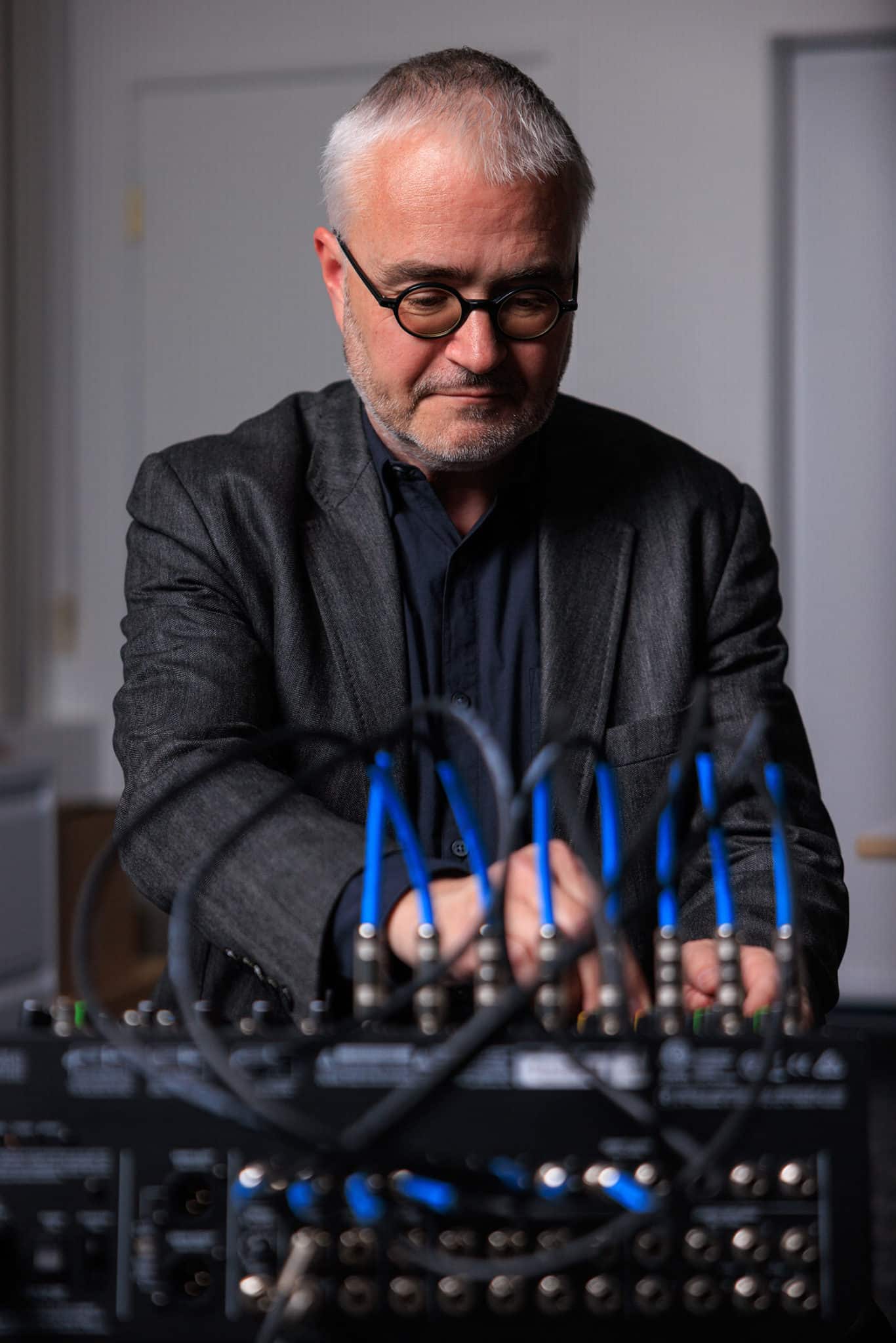 Dean Straebel at work with mixing console's blue wires in foreground